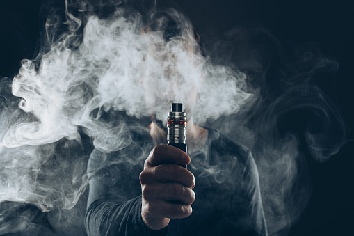 man holding vape mod