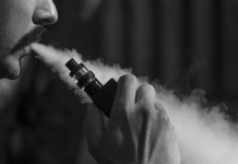 man blowing vapor