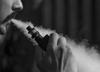 man blowing vapor