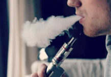 man blowing vapor