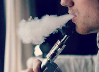 man blowing vapor