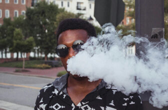 Man Blowing Vapor In Street